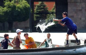Pool Photo #2 On a searing mid-summer’s day, young boys seek relief from the heat in the public fountain in Republic Square in downtown Yerevan.