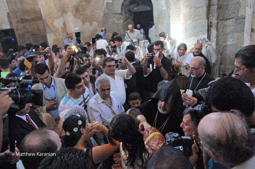 Two young women from Van are baptized at Sourp Khatch, the Church of the Holy Cross, at Aghtamar on Sept. 8. Three others were also baptized that day during the same ceremony. (Photo by Matthew Karanian)